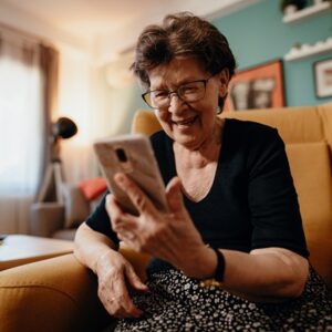 senior woman video calling on cellphone at home